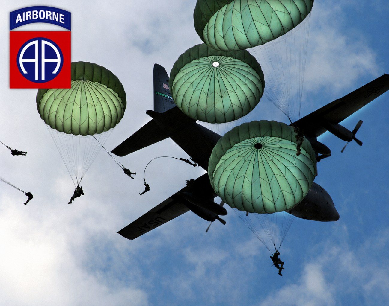 Paratroopers of the 82nd Airborne jumping from a C-130, with the 82nd Airborne insignia